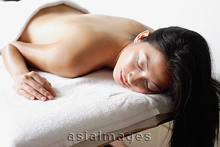 Asia Images Group - Woman lying on massage table, eyes closed