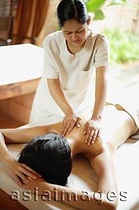 Asia Images Group - Woman on massage table receiving back massage