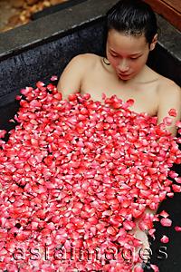 Asia Images Group - Woman relaxing in tub, eyes closed