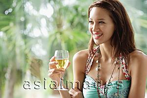 Asia Images Group - Woman holding wine glass, smiling, looking away