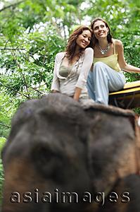 Asia Images Group - Young women on elephant, Phuket, Thailand