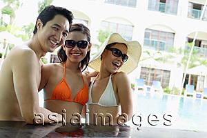 Asia Images Group - Two women and one man in swimwear, smiling