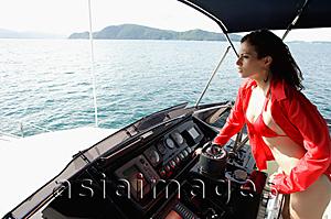 Asia Images Group - Woman at helm of yacht