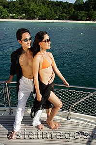 Asia Images Group - Couple on boat deck, man with arms around woman