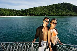 Asia Images Group - Couple on boat deck, looking at camera