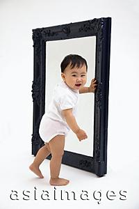 Asia Images Group - Baby boy standing next to mirror, smiling at camera