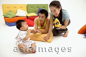 Asia Images Group - Young parents with one child, bonding in living room
