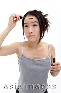 Asia Images Group - Woman applying mascara