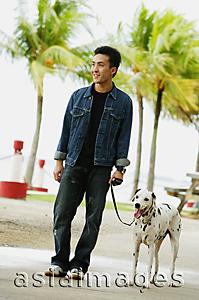 Asia Images Group - Man walking his dog