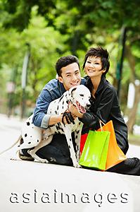 Asia Images Group - Couple embracing Dalmatian