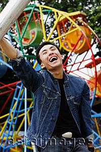 Asia Images Group - Young man at playground, smiling