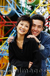 Asia Images Group - Couple at playground, smiling at camera