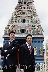 Asia Images Group - Businessmen standing in front of Hindu temple