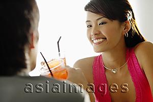 Asia Images Group - Couple having drinks, sitting face to face