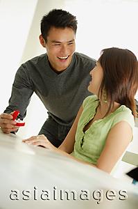 Asia Images Group - Man presenting woman with ring in box