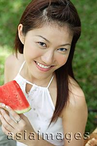 Asia Images Group - Woman with slice of watermelon, smiling at camera
