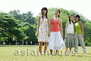 Asia Images Group - Young women standing side by side in field