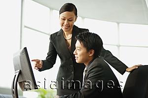 Asia Images Group - Businessman and businesswoman looking at computer