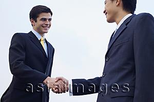 Asia Images Group - Businessmen shaking hands, low angle view