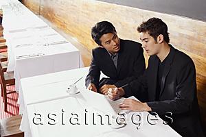 Asia Images Group - Two men sitting at table in restaurant, using laptop