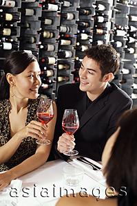 Asia Images Group - Young adults in restaurant, holding wine glasses