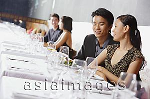 Asia Images Group - Couples dining in restaurant, man smiling at camera