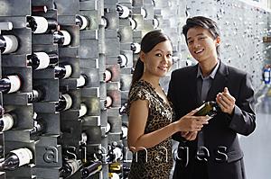 Asia Images Group - Couple in wine cellar, looking at camera