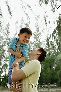 Asia Images Group - Father lifting son