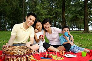 Asia Images Group - Family of four, having a picnic, smiling at camera