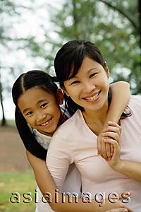 Asia Images Group - Mother with daughter, smiling at camera