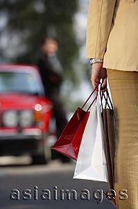 Asia Images Group - Woman carrying shopping bags, cropped image