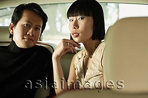 Asia Images Group - Couple sitting in car interior, looking at camera
