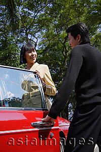 Asia Images Group - Man opening car door for woman