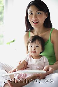 Asia Images Group - Mother with young daughter, smiling at camera