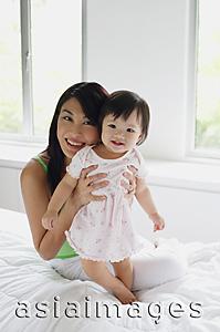 Asia Images Group - Mother embracing baby girl, smiling at camera