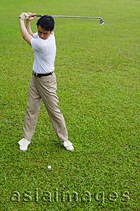 Asia Images Group - Man swinging golf club