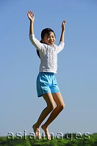 Asia Images Group - Girl jumping in mid air, smiling at camera