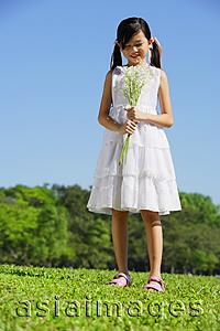 Asia Images Group - Girl wearing white dress, holding bouquet of flowers