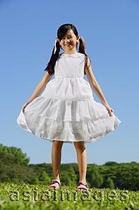 Asia Images Group - Girl in white dress, smiling at camera