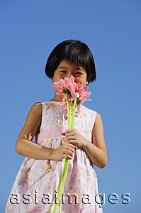 Asia Images Group - Girl smelling bouquet of flowers