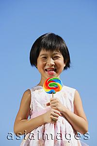 Asia Images Group - Girl licking lollipop, portrait