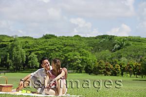 Asia Images Group - Couple sitting in park, having a picnic