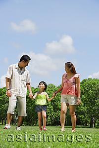 Asia Images Group - Family with one child walking in park, holding hands