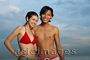 Asia Images Group - Couple standing against sky at dusk, smiling