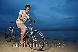 Asia Images Group - Man cycling with tandem bicycle