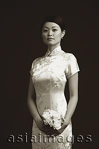 Asia Images Group - Woman in cheongsam holding bouquet of flowers, portrait