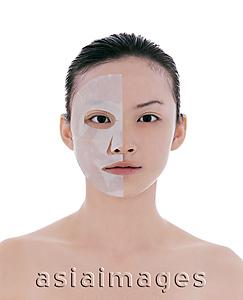 Asia Images Group - Young woman looking at camera, wearing half a face mask
