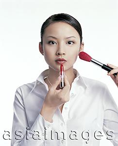 Asia Images Group - Young woman applying make-up