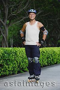 Asia Images Group - Mature adult with roller blades, standing with hands on hips