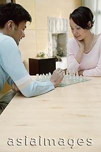 Asia Images Group - Couple at home playing chess